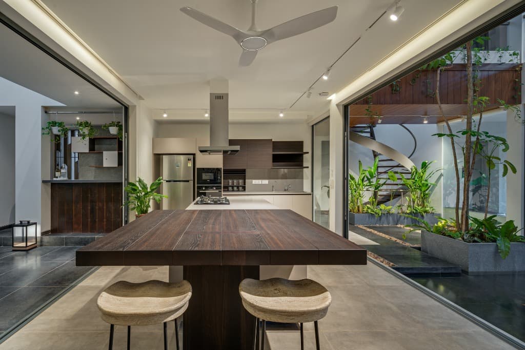 Cantilevered solid timber dining bar looking out to the central internal court and spiral staircase
