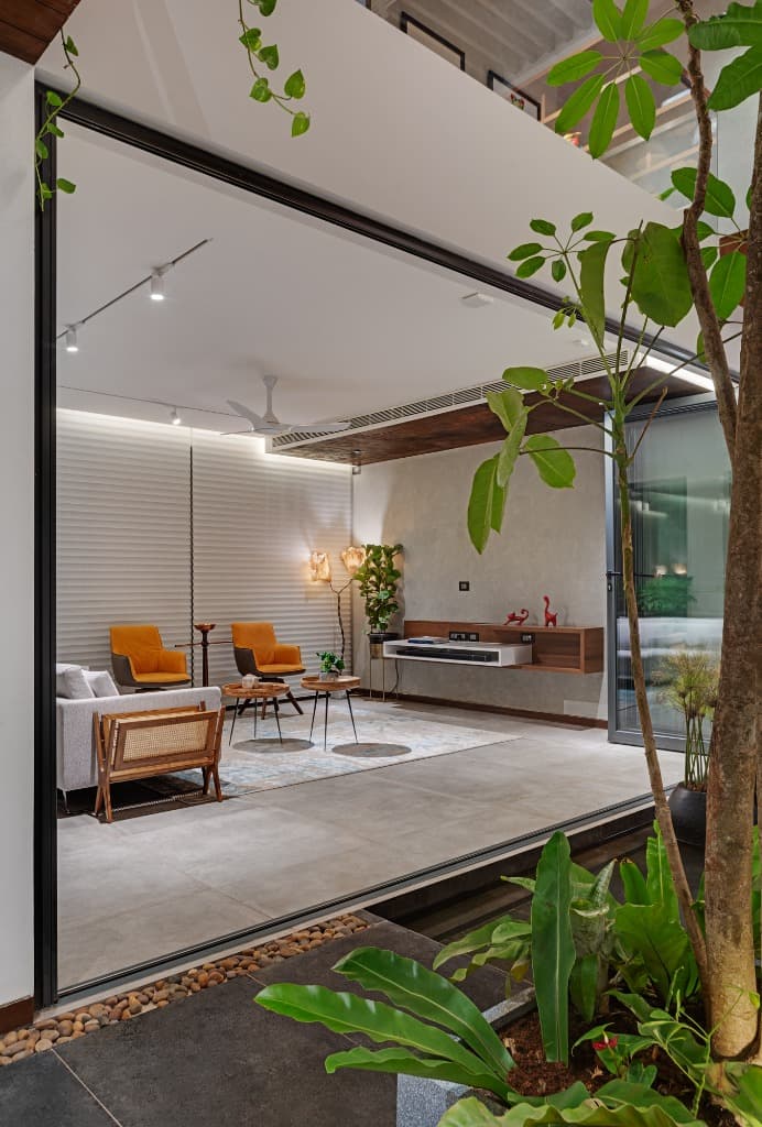 Evening courtyard perspective looking into the formal living salon with soft ambient lighting