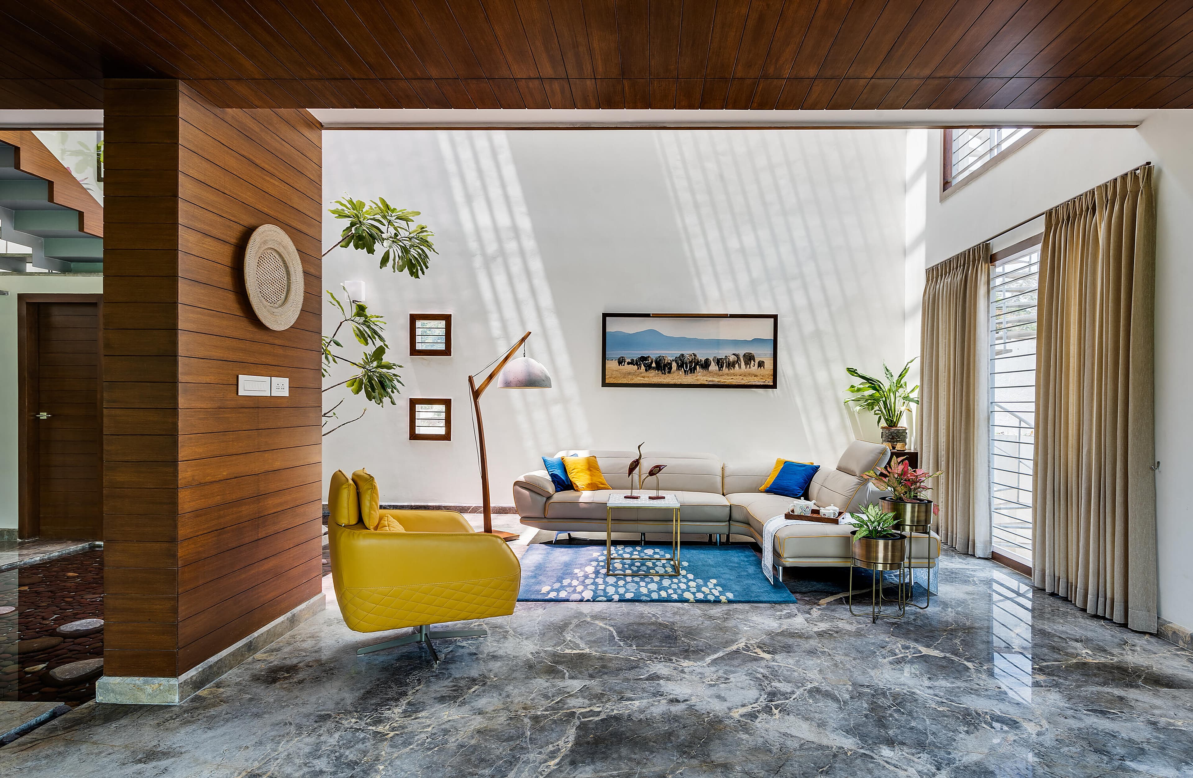 Ground-floor living pavilion opening seamlessly to garden greenery and outdoor light