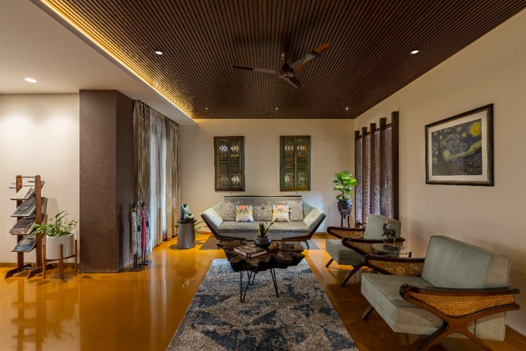 Formal drawing salon featuring mid-century seating, live-edge tree trunk coffee table, and vintage wooden wall art shutters