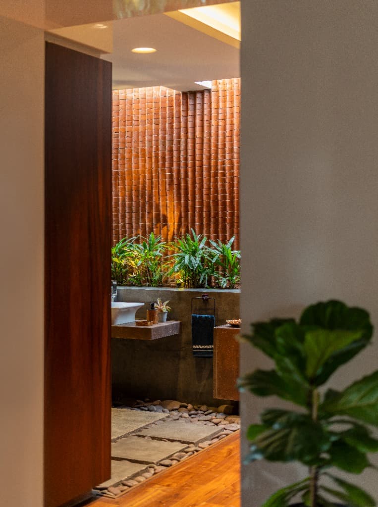 Open-Air Powder Room with River Pebbles & Terracotta