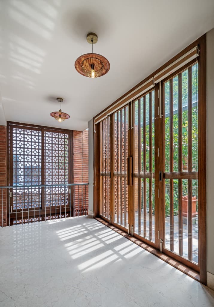 Sunlit Teak Louver Corridor & Jali Shadows