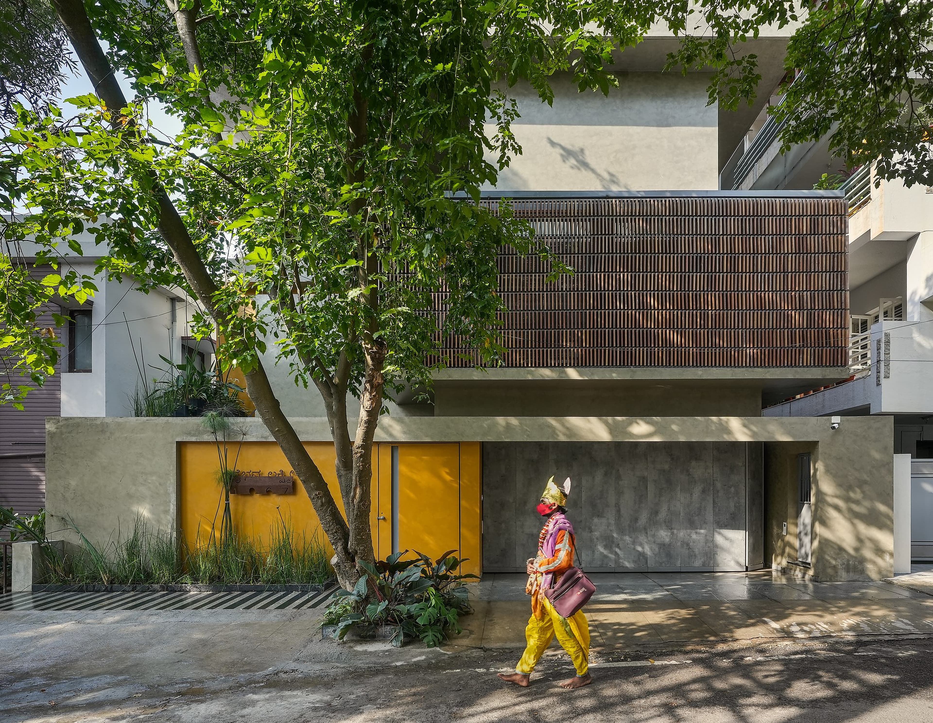 Twilight exterior view of cantilevered cubes and timber louvers