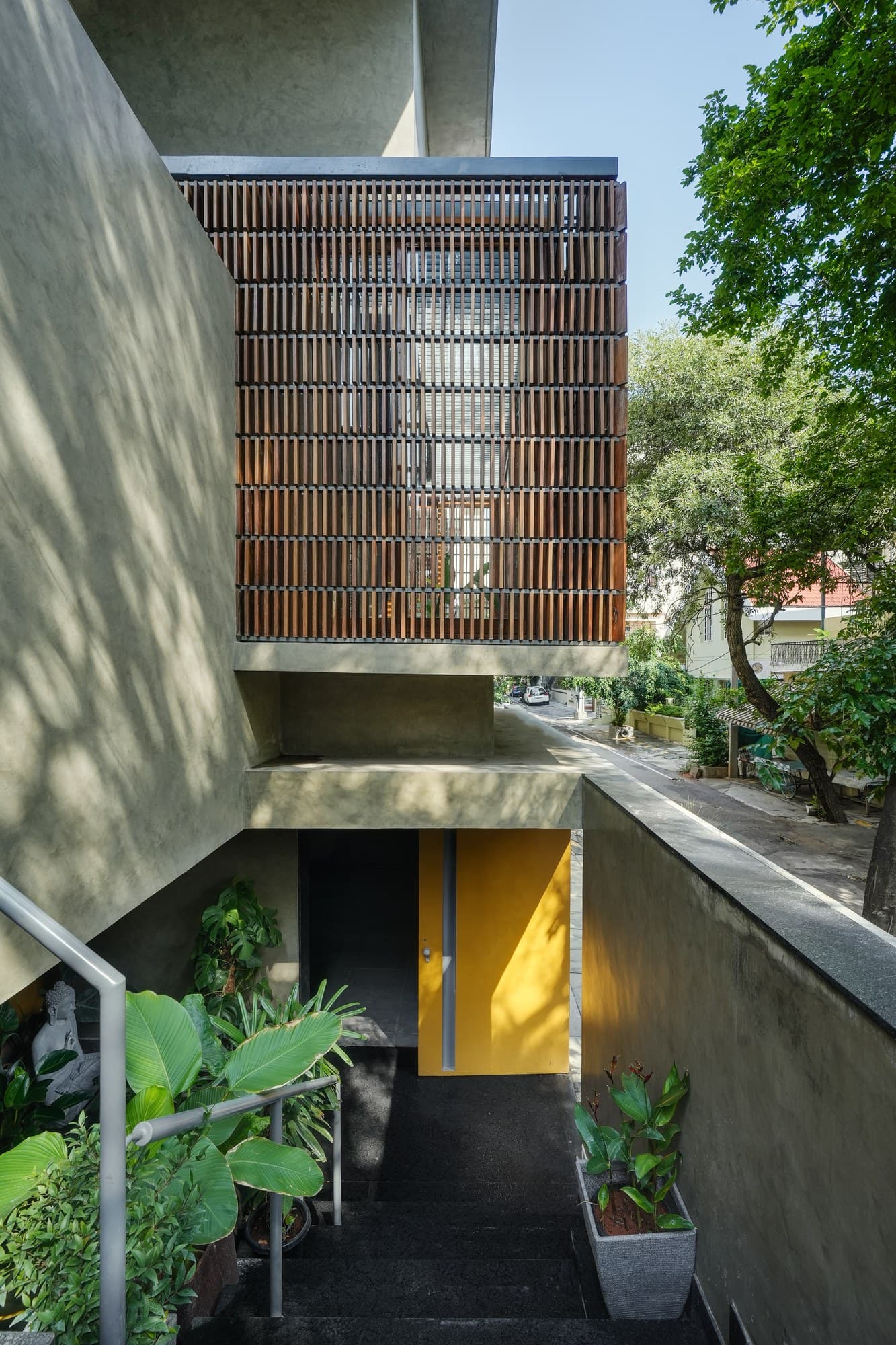 Geometric concrete frame canopy surrounded by tropical foliage