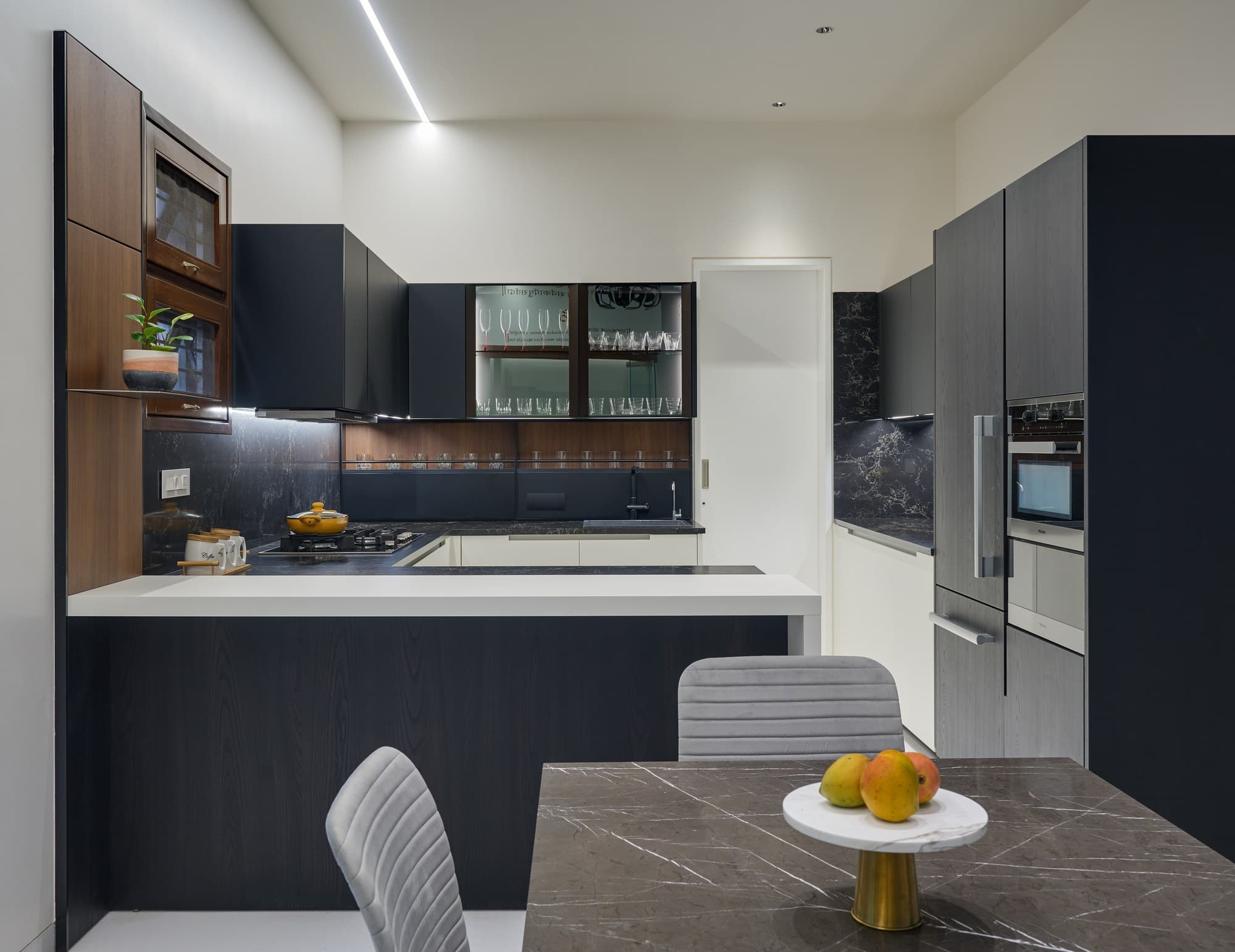 Modern open kitchen with fluted charcoal cabinetry and quartz island counter