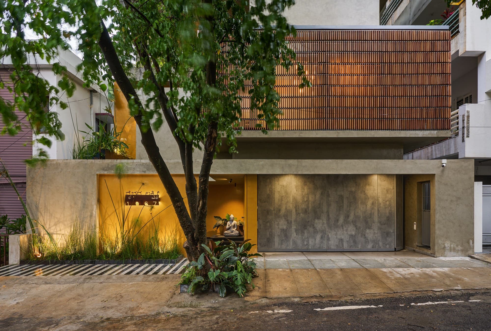 Signature street elevation highlighting mustard-yellow entry portal and timber louvers